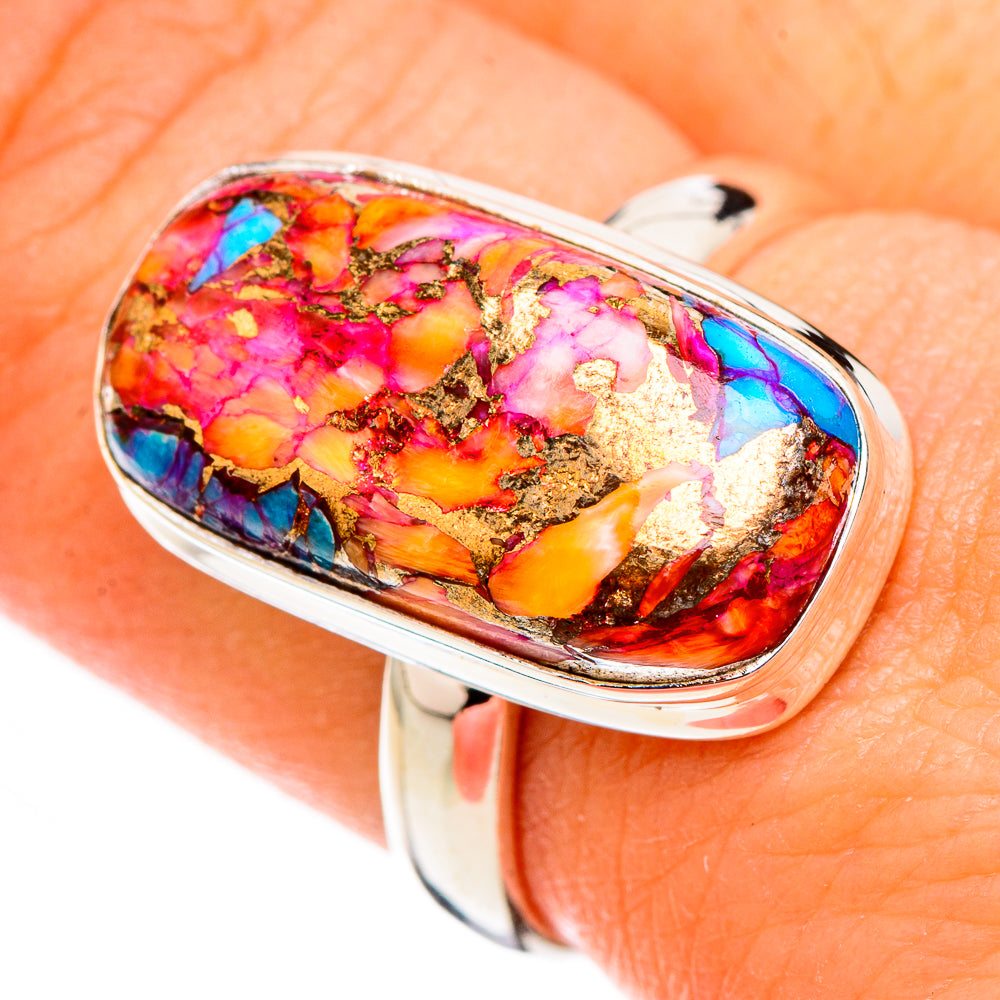 Sterling silver oval gemstone ring close-up on hand, blue and pink with gold flecks