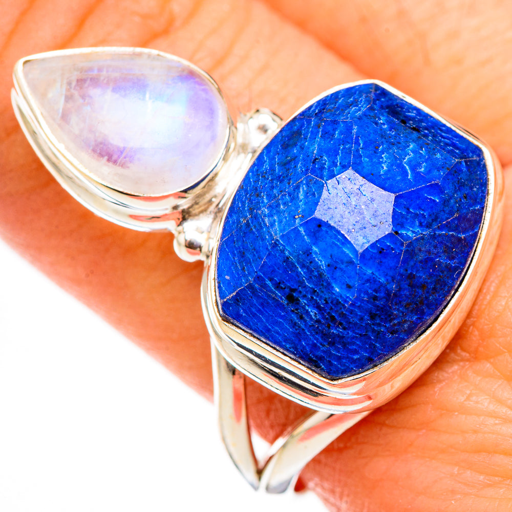 Sterling silver ring with moonstone bezel above faceted blue lapis lazuli cabochon