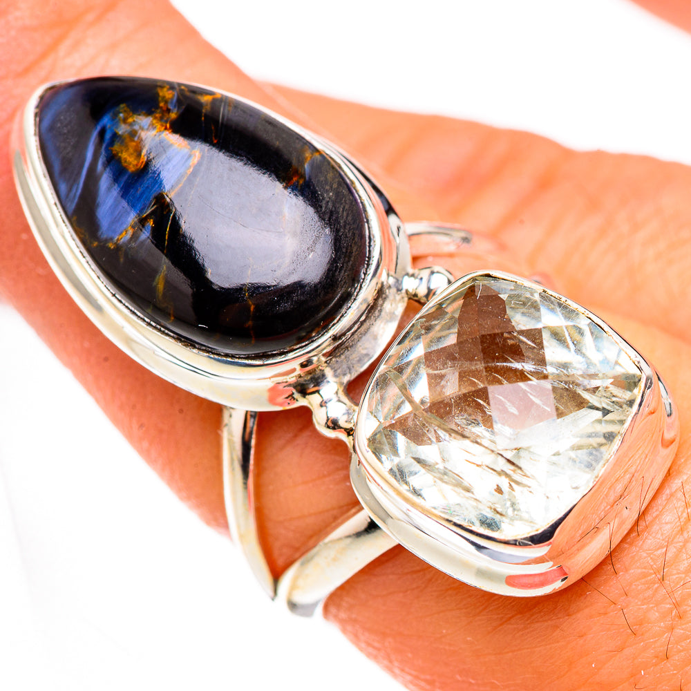 Sterling silver statement ring showing oval dark blue gemstone and oval clear faceted stone