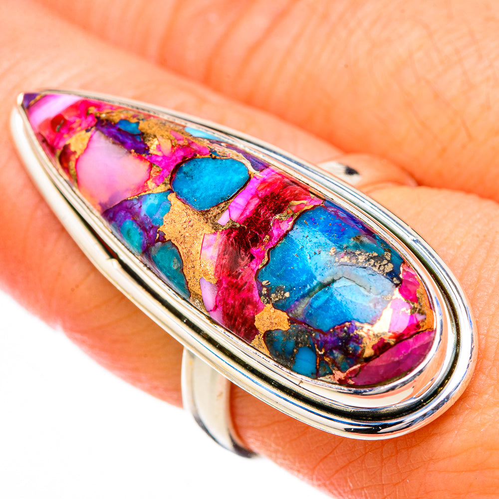 Close-up oval ring showing multicolor mosaic inlay in pink, blue, and gold