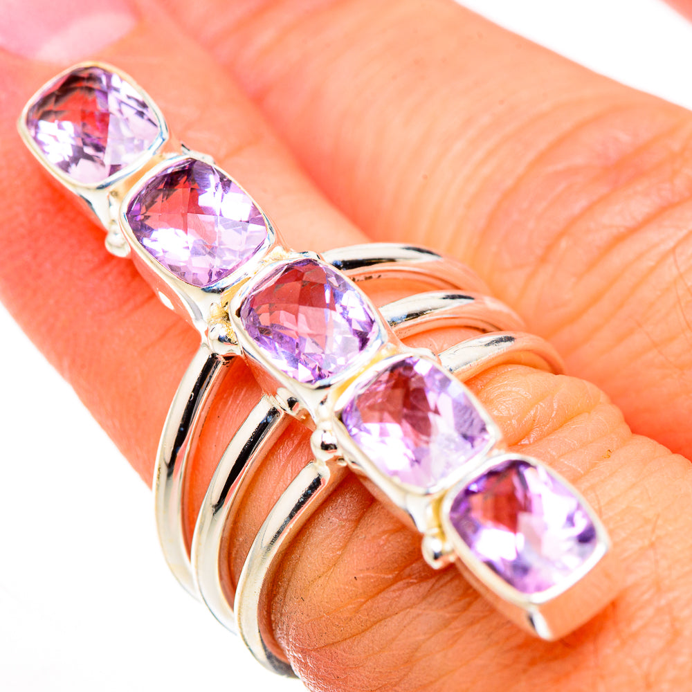 Sterling silver amethyst ring with five faceted oval pink stones, worn on hand