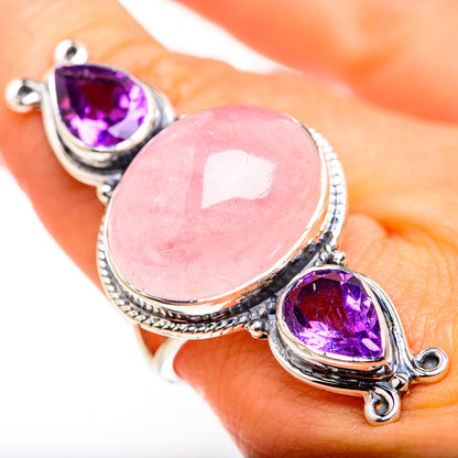 Sterling silver ring on hand, oval pink rose quartz center with purple amethyst side stones