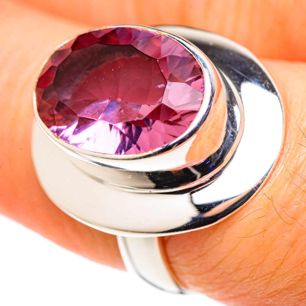 Sterling silver oval ring with faceted pink gemstone center, close-up view