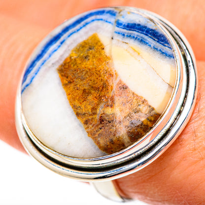 Sterling silver oval ring with blue-striped scheelite cabochon and yellow-brown matrix