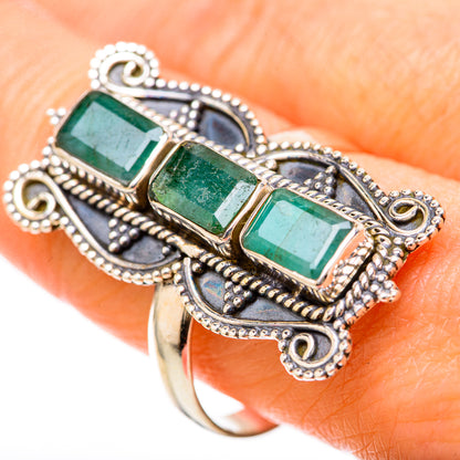 Sterling silver ring with three green emerald-cut stones and dark blue accents
