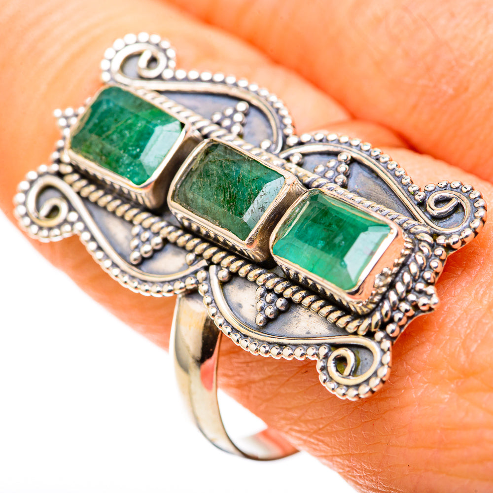 Silver-tone ring with three rectangular green emerald-style stones and ornate scrollwork