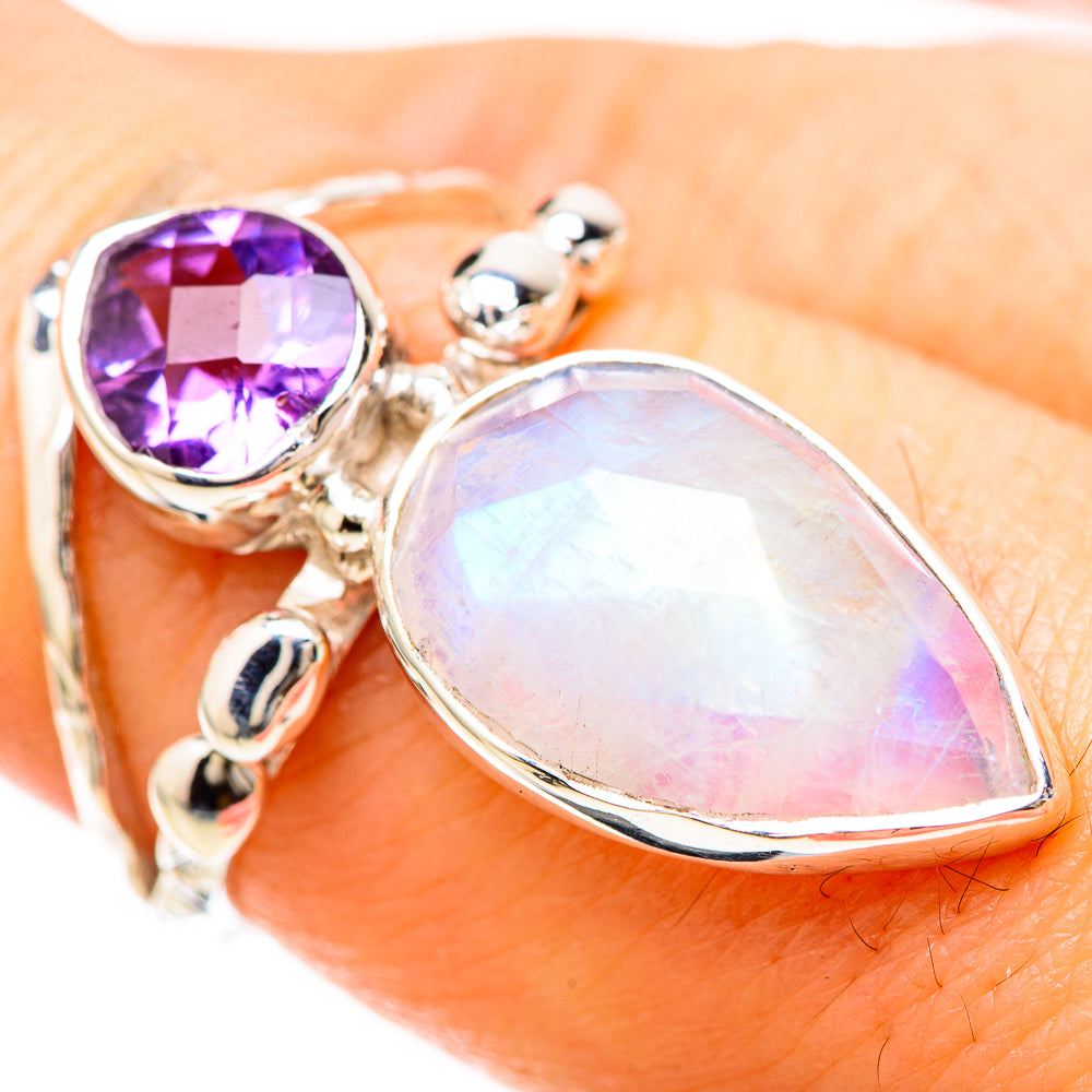 Sterling silver ring closeup with purple amethyst and opalescent teardrop moonstone on band