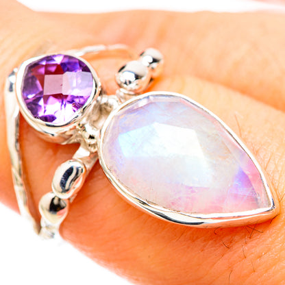 Sterling silver ring closeup with purple amethyst and opalescent teardrop moonstone on band