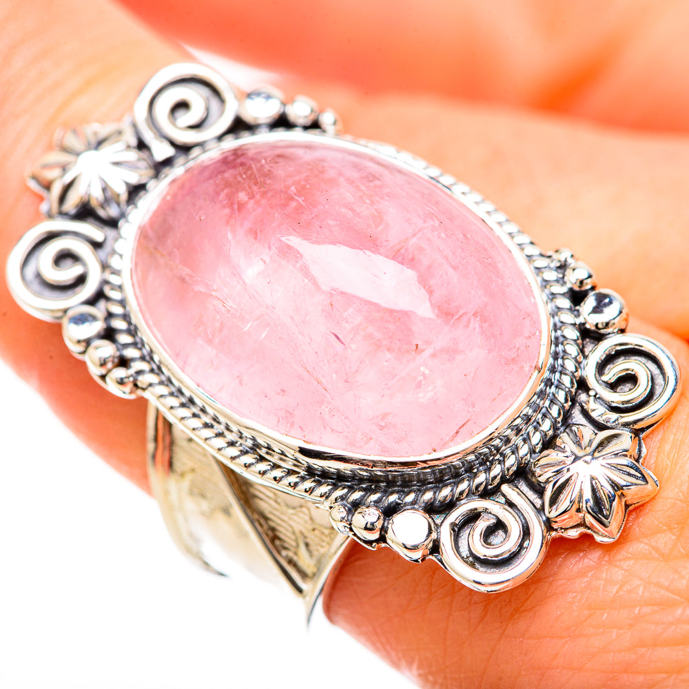 Sterling silver rose quartz oval ring on finger, detailed swirl and beaded edge