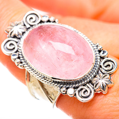 Sterling silver rose quartz oval ring on finger, detailed swirl and beaded edge