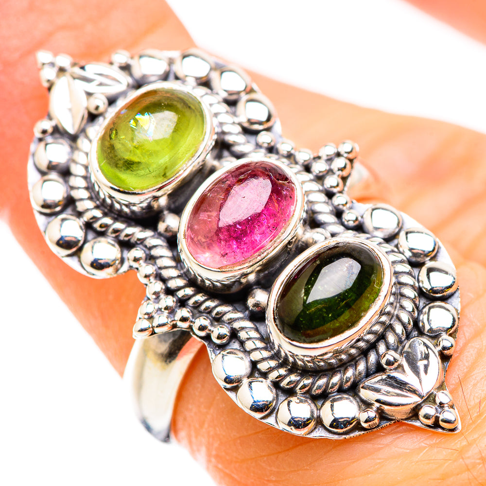 Sterling silver ring with three oval gemstones: green, pink, and green in ornate settings.