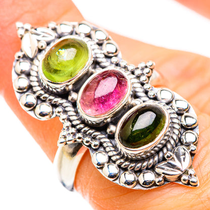 Sterling silver ring with three oval gemstones: green, pink, and green in ornate settings.