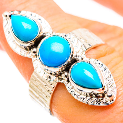 Turquoise triple-stone ring on finger with textured silver bezels