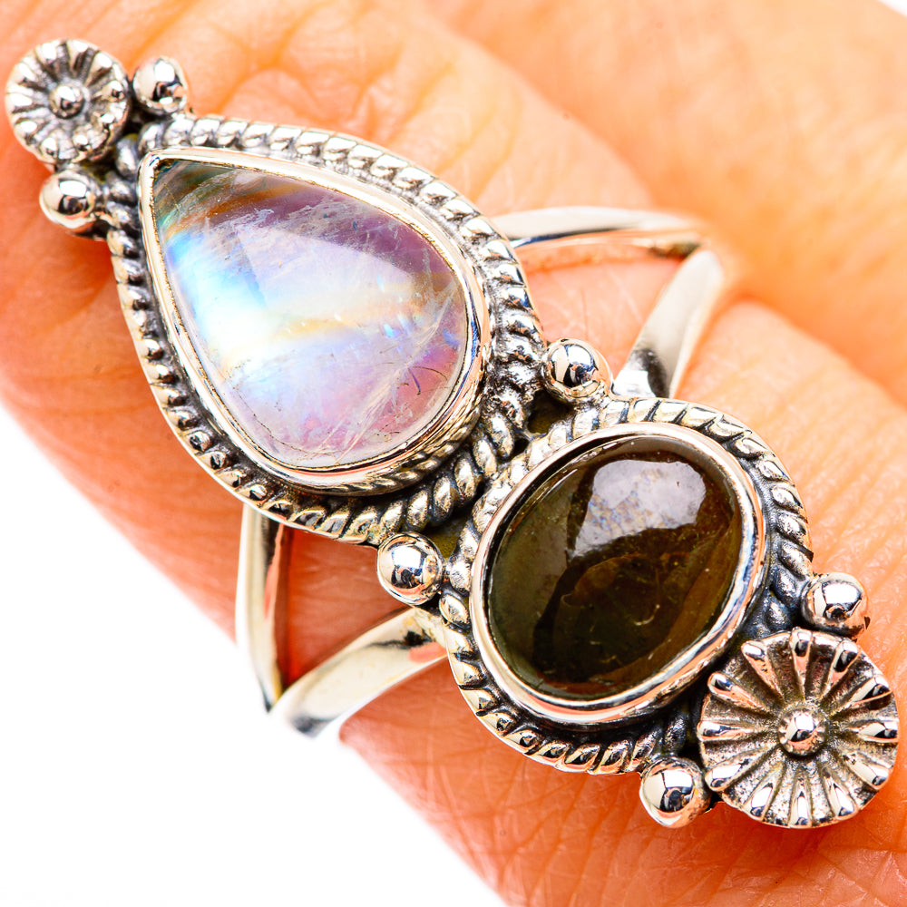 Sterling-silver ring with iridescent oval stone and dark round gemstone