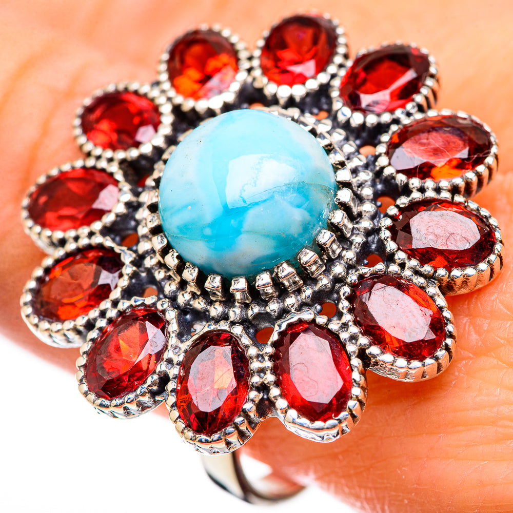 Sterling silver ring with oval turquoise Larimar center and red garnet halo, prong-set