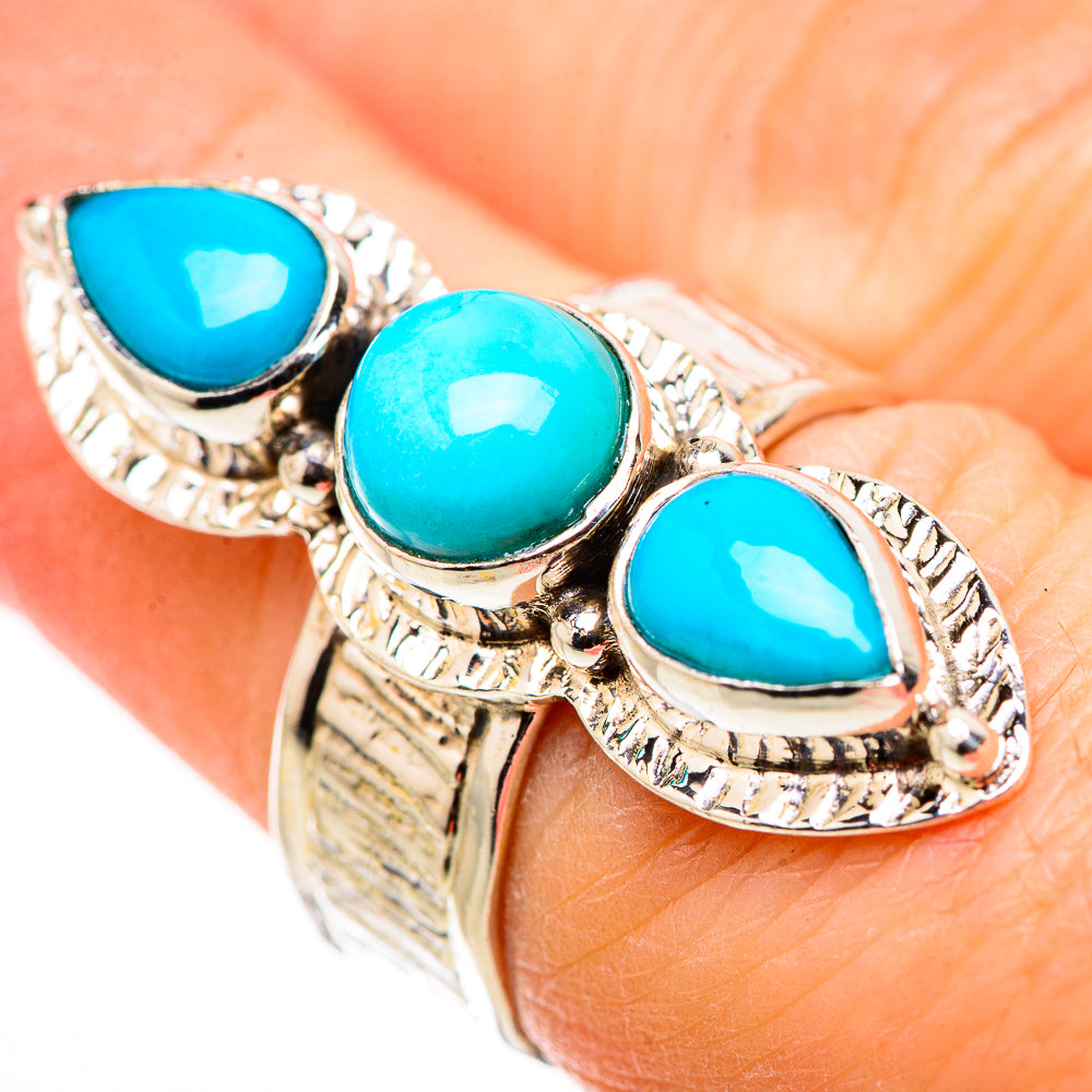 Silver ring with three turquoise teardrop stones and ornate rope-like bezels