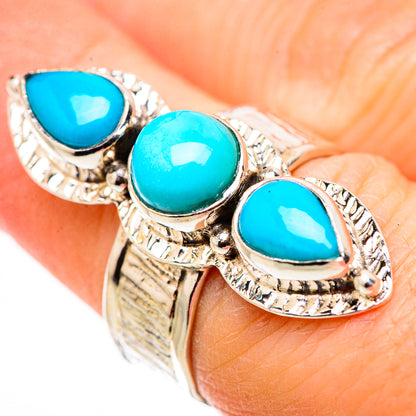 Silver ring with three turquoise teardrop stones and ornate rope-like bezels