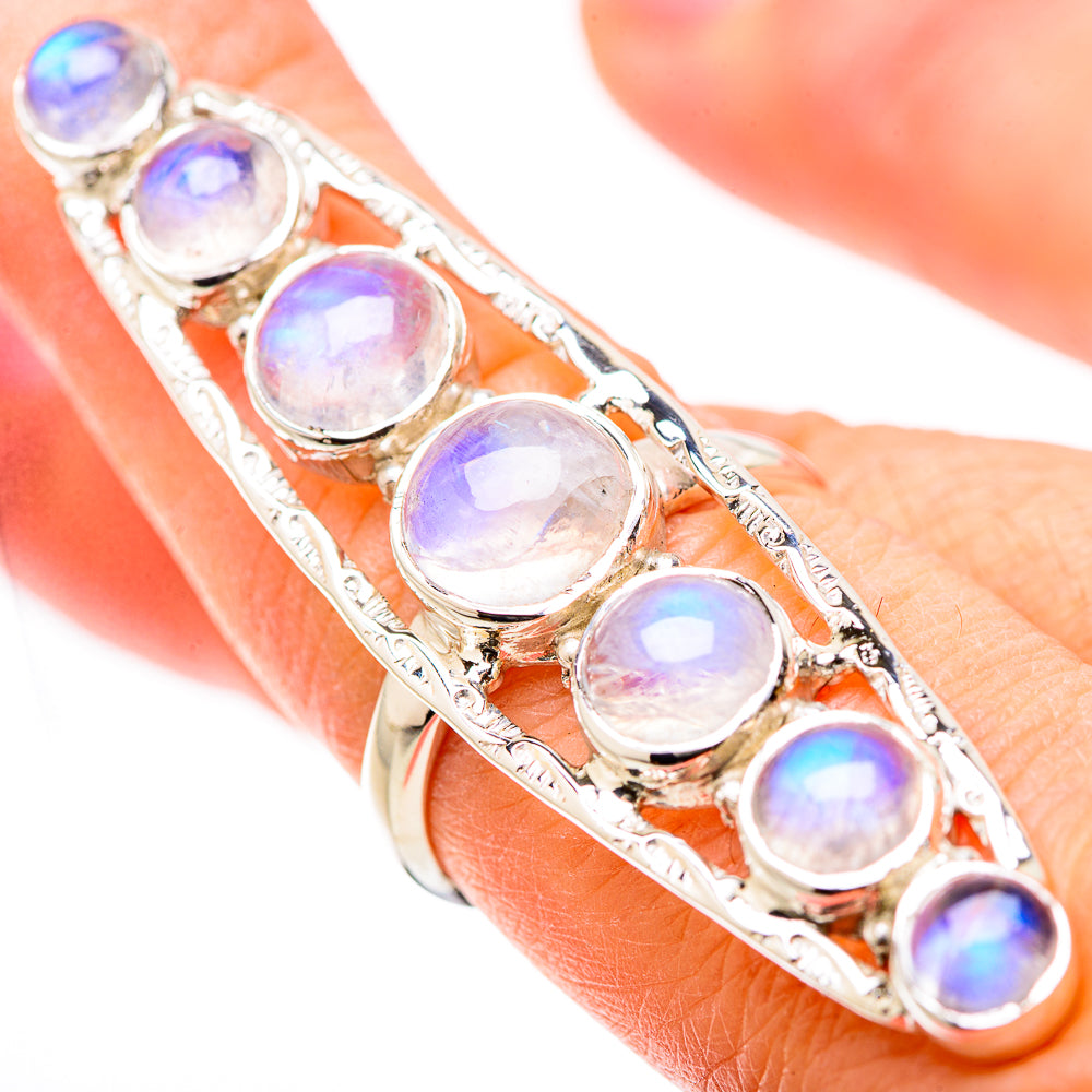 Rainbow moonstone ring on hand, showing iridescent round stones in silver settings