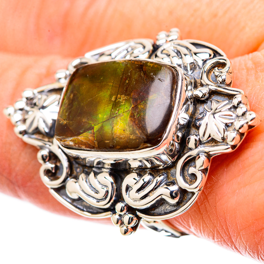 Sterling silver ring with rectangular green-yellow ammolite centerpiece and ornate scrollwork