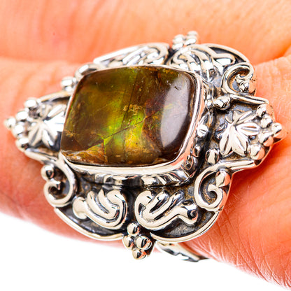 Sterling silver ring with rectangular green-yellow ammolite centerpiece and ornate scrollwork