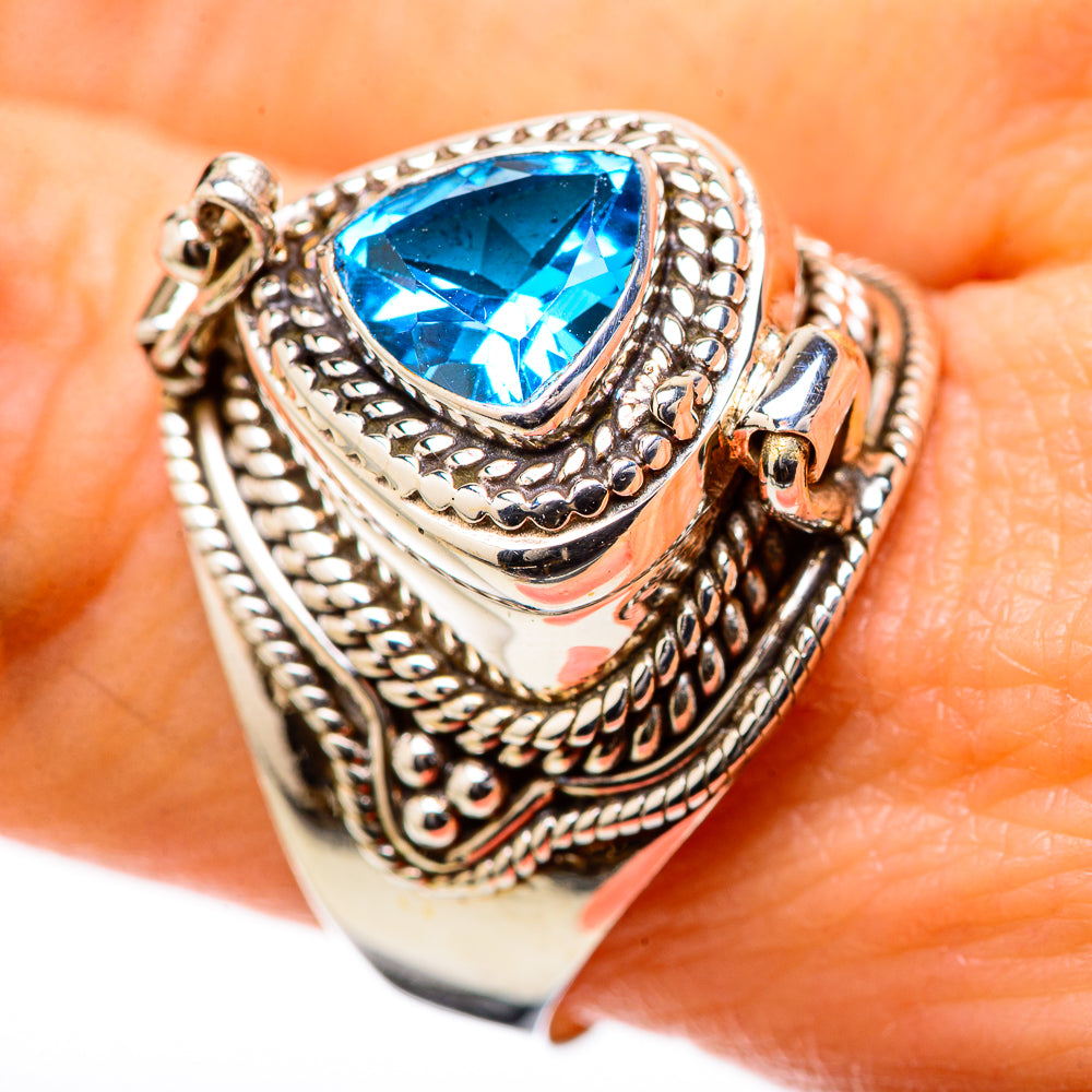 Sterling silver blue topaz pear-cut ring with braided borders and raised prong setting