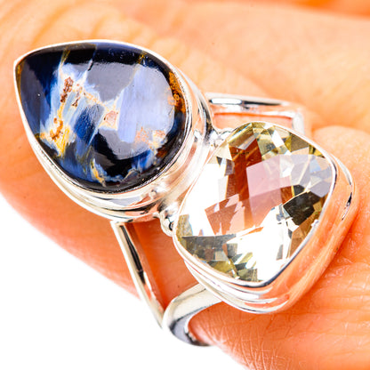 Two-stone sterling silver ring with dark blue teardrop gem and yellow-green gem