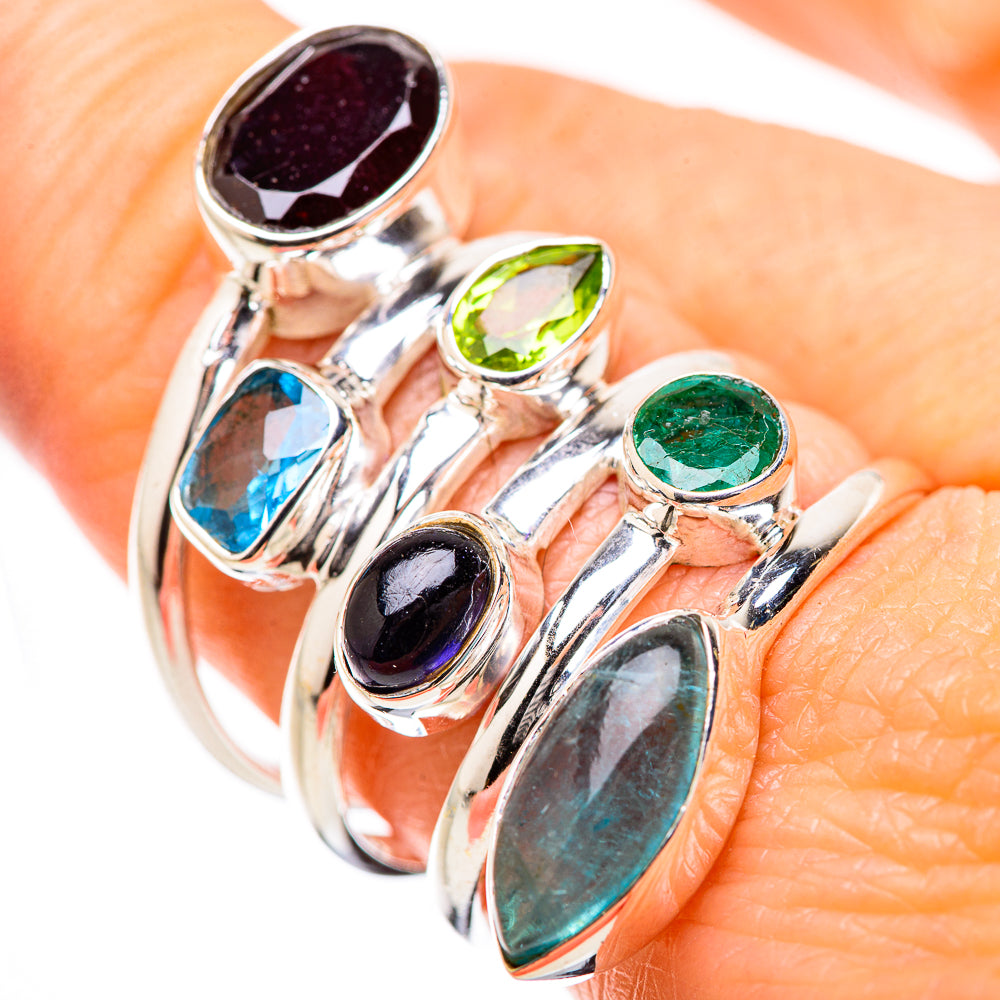 Sterling silver gemstone ring on finger, featuring oval green and blue stones