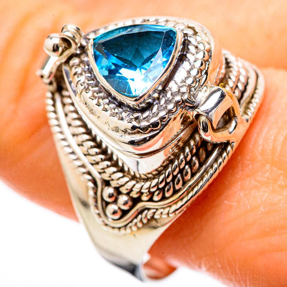 Silver-tone engraved ring with blue teardrop gemstone on patterned band