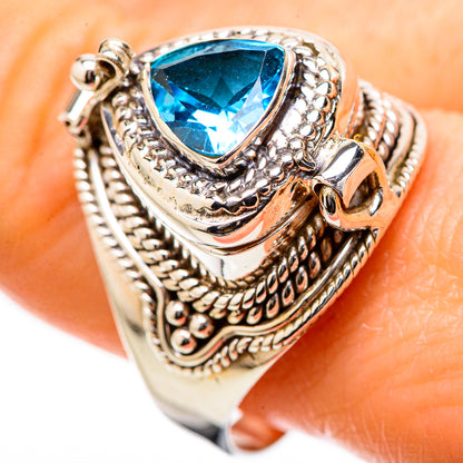 Silver-tone engraved ring with blue teardrop gemstone on patterned band