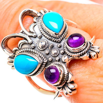 Ornate sterling silver ring with turquoise and amethyst cabochon stones, filigree detail