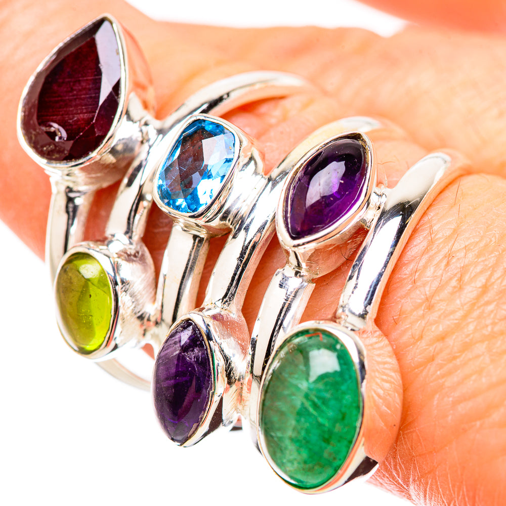 Silver gemstone ring with teal-blue, purple, green, and red oval stones in prong settings