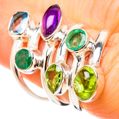 Multistone ring with green, purple, blue, and yellow oval gemstones on prong settings