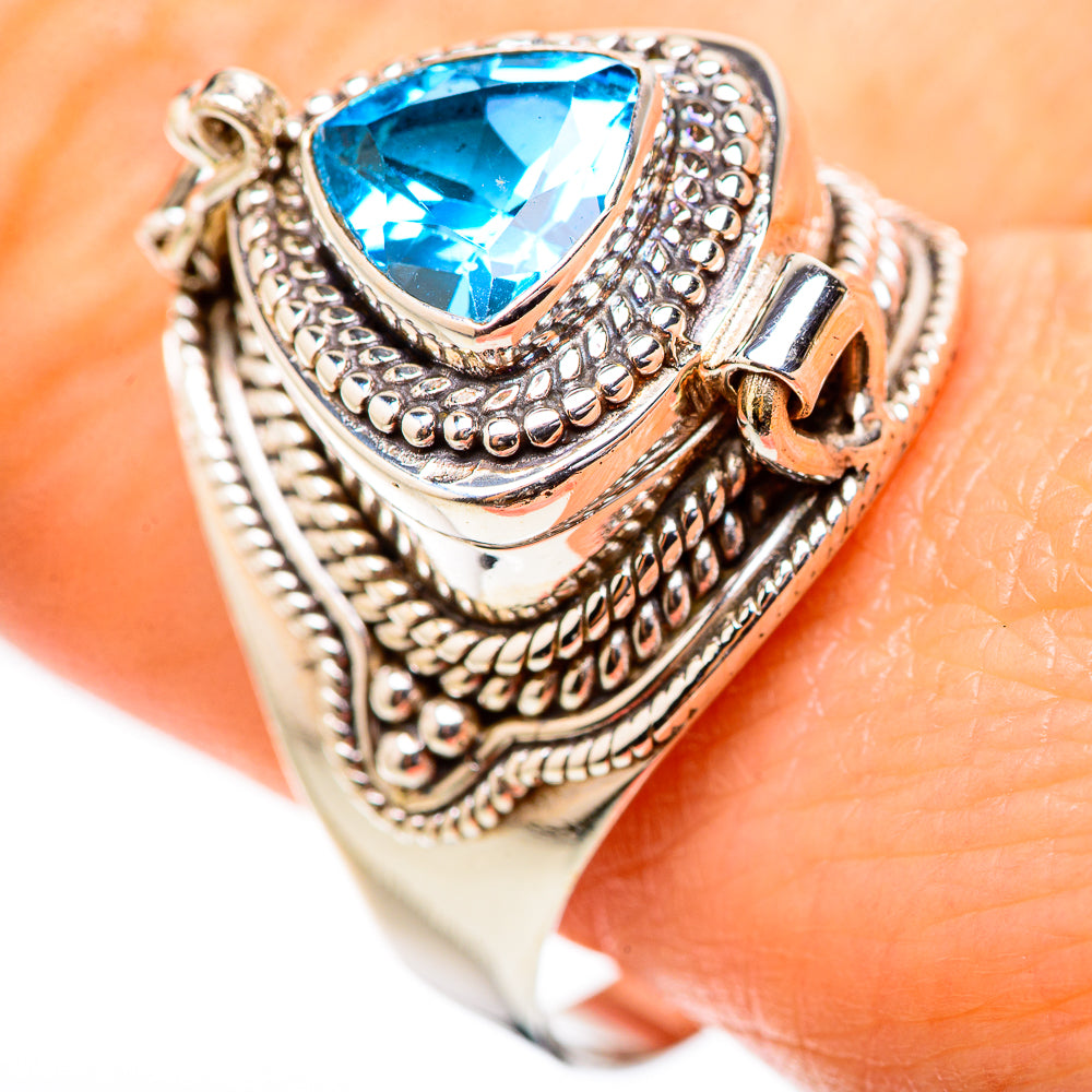 Sterling silver ring with large blue teardrop gemstone and textured bezel, side view