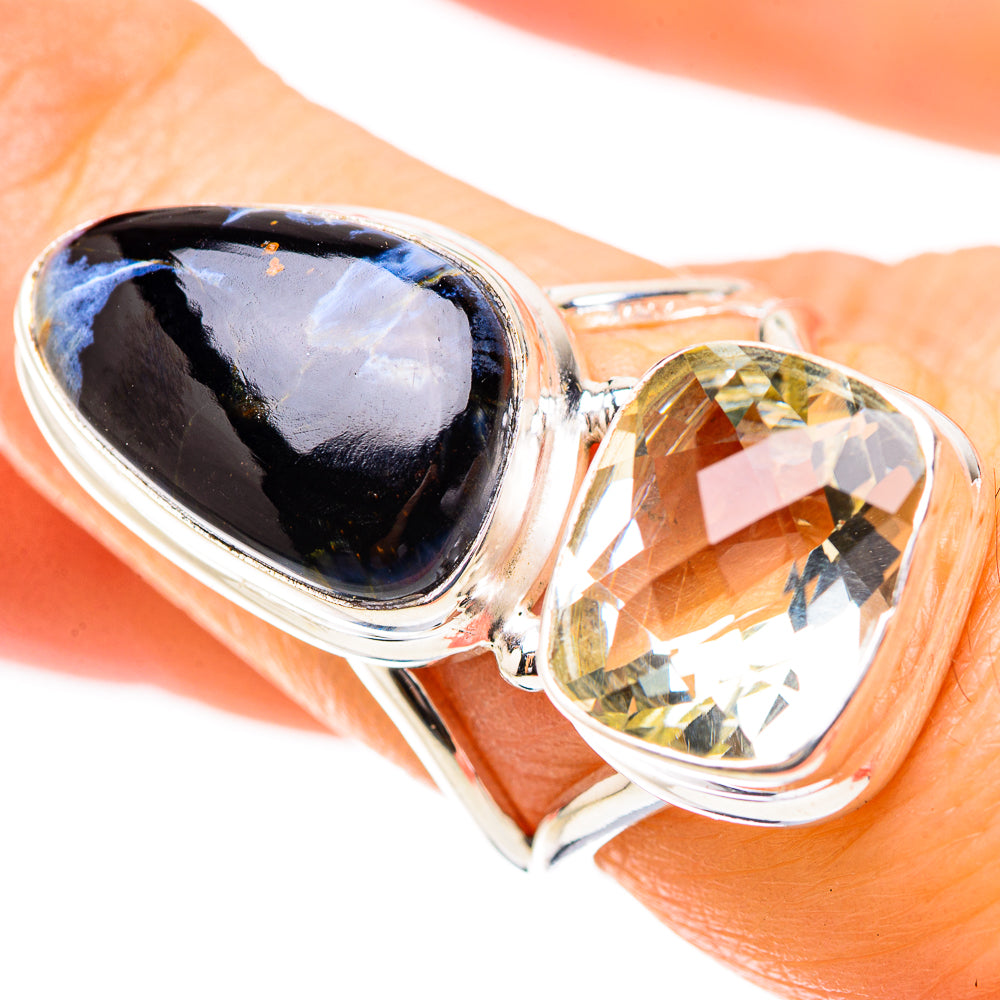 925 sterling silver ring close-up on skin: dark oval stone and yellow oval gemstone