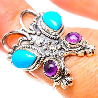 Silver statement ring with two turquoise and two amethyst cabochons, on finger