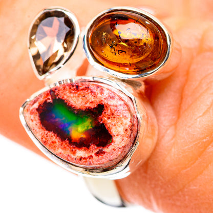 Sterling silver ring close-up with red-black opal oval, amber round stone, and clear teardrop