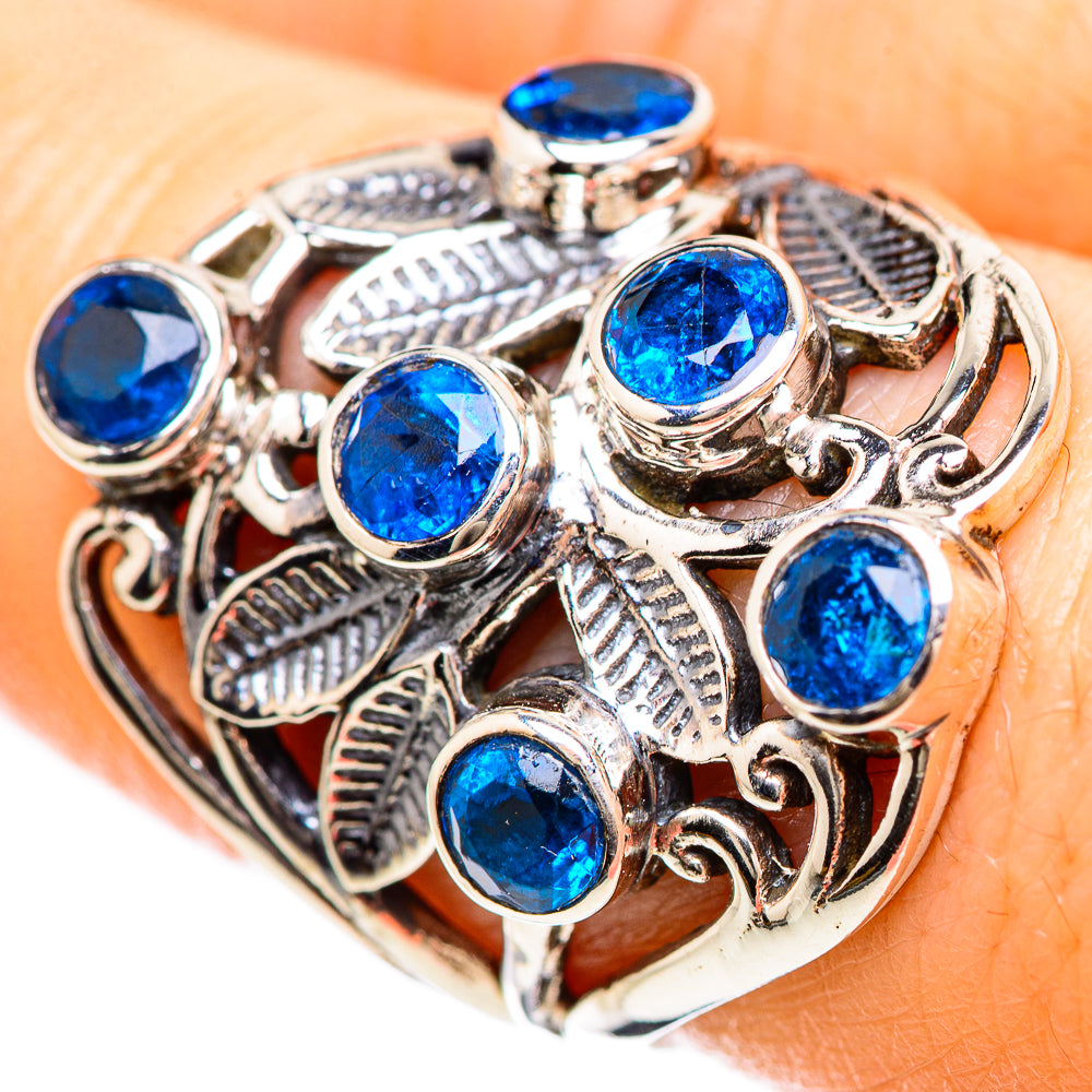 Silver ring with oval blue gemstones and ornate filigree setting