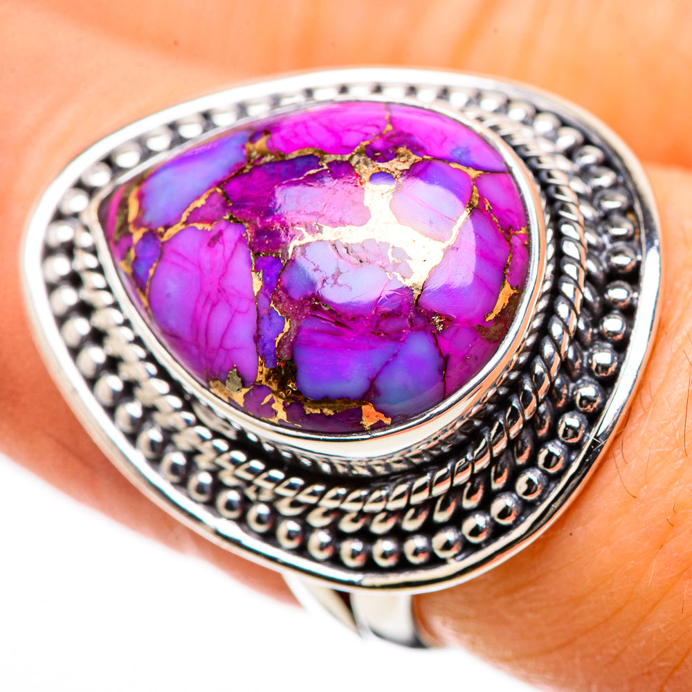 Purple oval turquoise cabochon ring with gold-toned matrix, ornate silver band