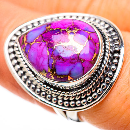 Purple oval turquoise cabochon ring with gold-toned matrix, ornate silver band