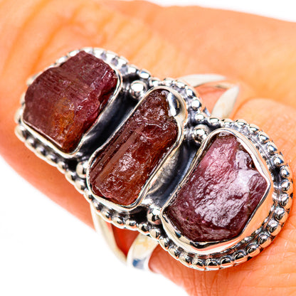 Sterling silver stack ring with three rough rose-pink tourmaline stones on hand