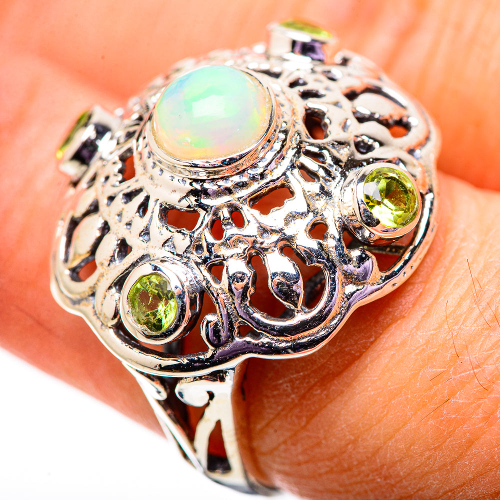 Sterling silver ring with round opal cabochon and green peridot side stones