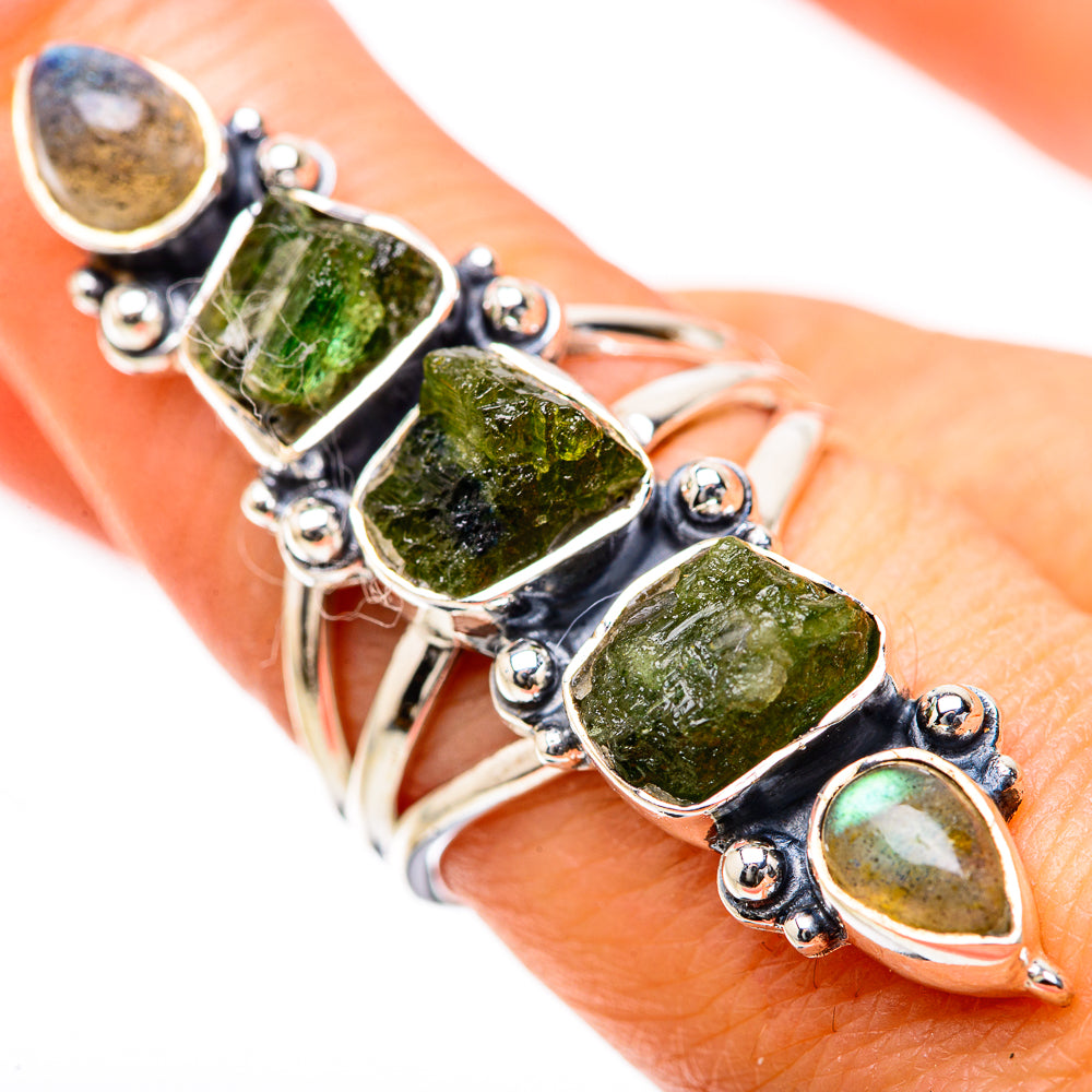 Sterling silver ring with faceted rough green stones on finger, teardrop labradorite