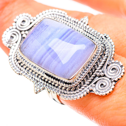 Sterling silver statement ring with rectangular iridescent stone on finger