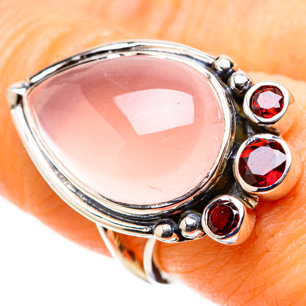 Sterling silver ring with pink rose quartz oval center and four garnet stones