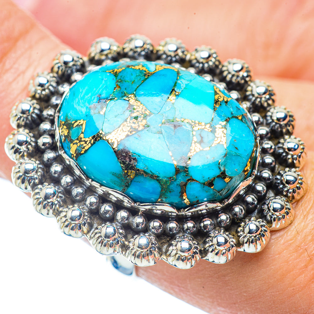 Sterling silver turquoise ring on finger with oval blue cabochon and matrix texture
