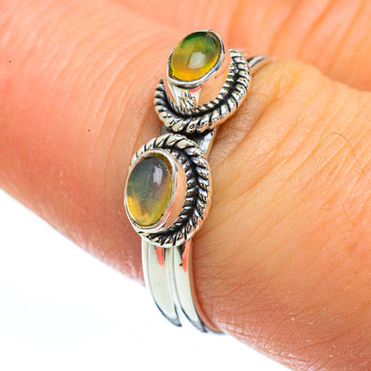 Sterling silver opal ring with two oval yellow-green stones and rope-textured settings