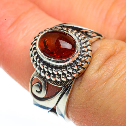 Sterling silver amber ring with oval red-brown Baltic amber and ornate filigree details