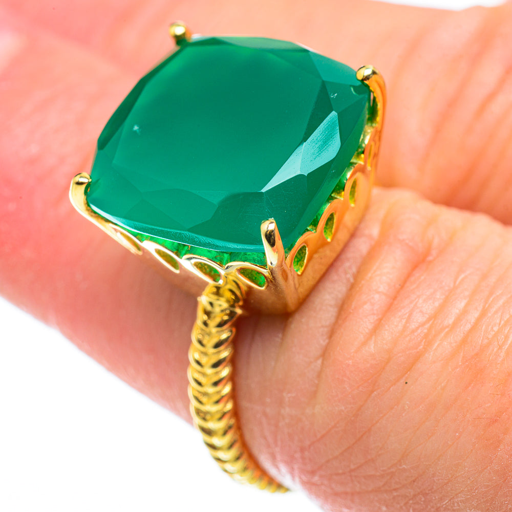 Gold ring with large green gemstone, prong-set setting