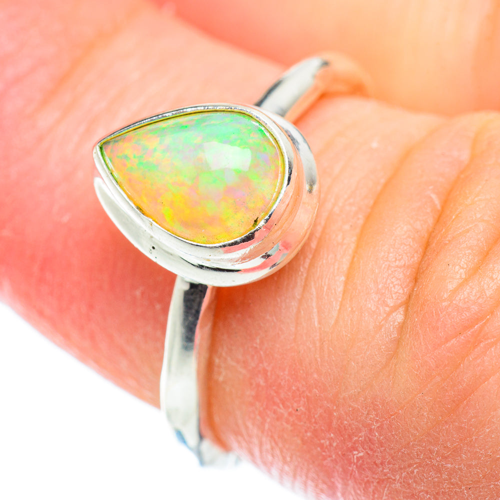 925 sterling silver opal ring with oval cabochon showing green-orange fire on finger