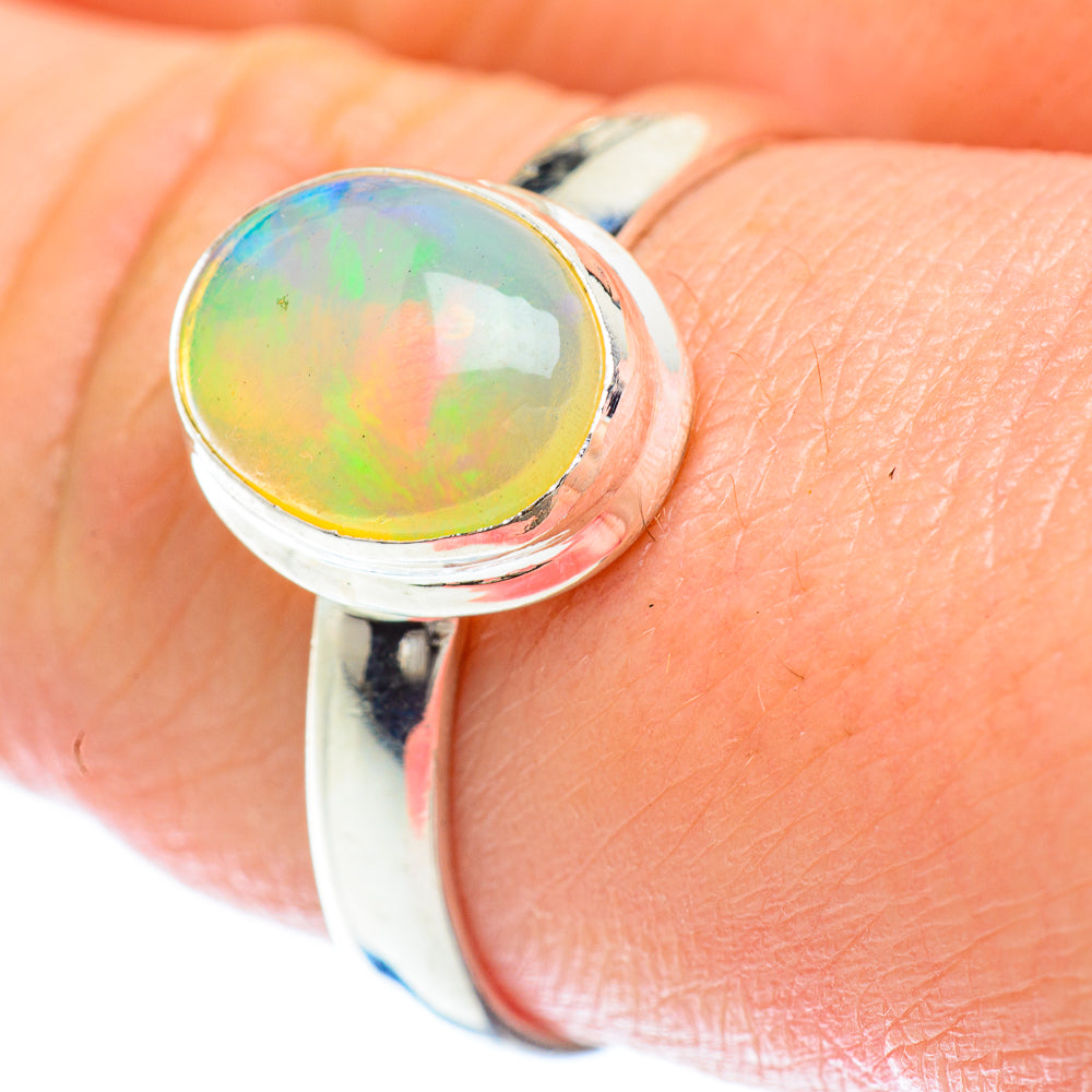 Sterling silver opal ring with iridescent round yellow-green-blue cabochon, size 9.75